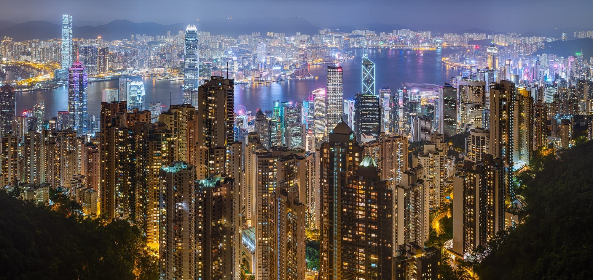 Victoria Harbour and the Hong Kong skyline lit up at night